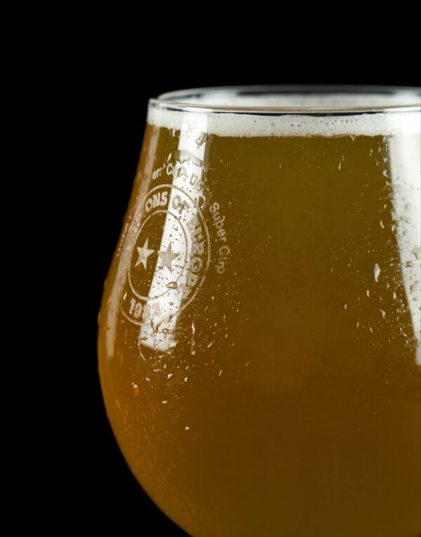 Close up photo of beer glass with Champions of Europe logo