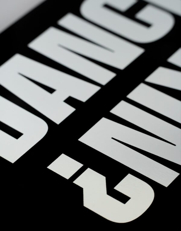 Close up of silver reflective letters on black paper